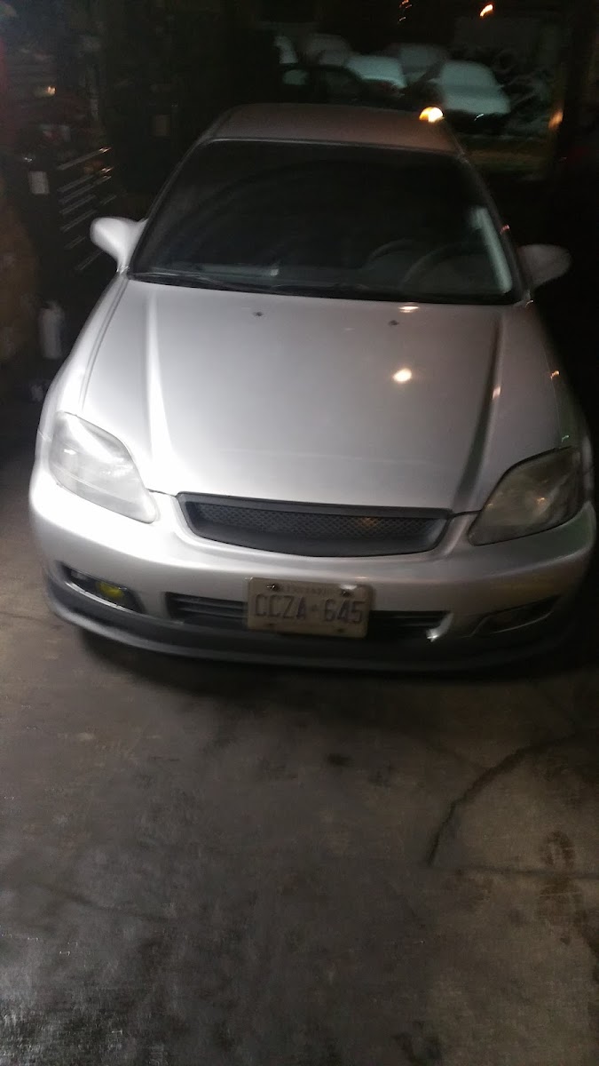 A customer car parked inside the shop